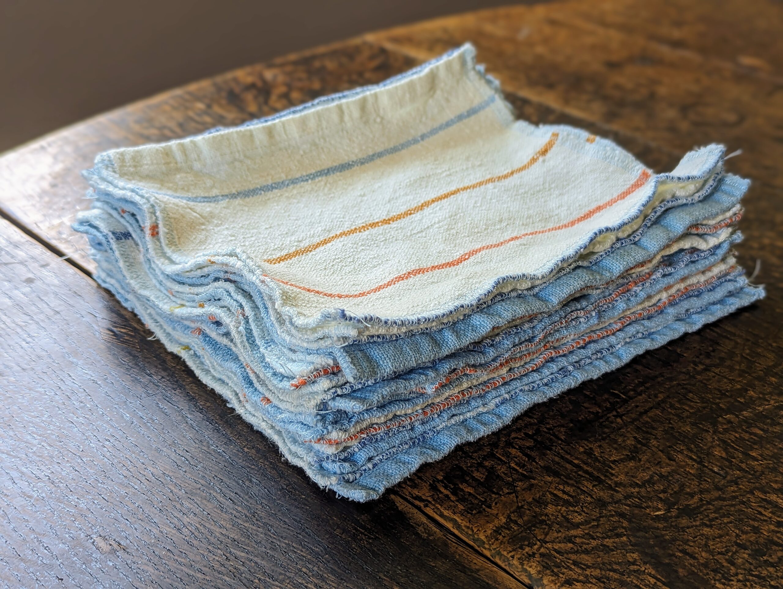 A stack of cotton dish cloths, not folded.
